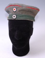 Lot 442 - A German Feldmutze with green banding, stamped...