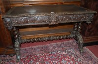 Lot 1108 - A circa 1900 heavily carved oak and rexine...