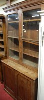 Lot 1119 - A late Victorian pitch pine bookcase cupboard...