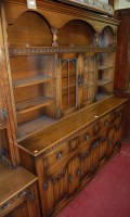 Lot 1121 - A contemporary moulded oak dresser, the twin...