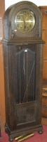 Lot 1123 - A 1930s moulded oak longcase clock, having a...
