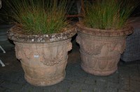 Lot 1139 - A pair of terracotta planters each of circular...