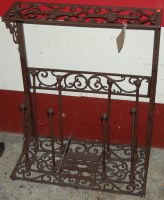 Lot 1146 - A contemporary floral pierced metal shoe rack,...