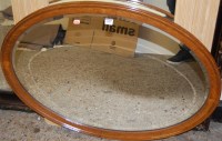 Lot 1150 - An early 20th century oak framed bevelled oval...
