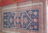 Lot 1163 - A Persian woollen blue ground rug having...