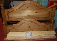 Lot 1171 - A contemporary pine double bedstead having...