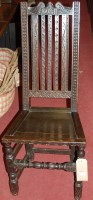Lot 1173 - An antique low relief carved oak slatback...