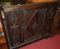 Lot 1182 - An early 20th century line carved oak single...