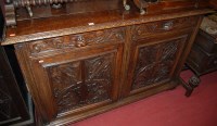 Lot 1185 - A circa 1900 heavily carved oak double door...