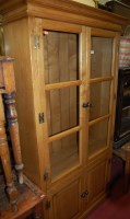 Lot 1198 - A contemporary light oak double door glazed...