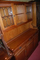 Lot 1224 - A contemporary moulded oak dresser having twin...