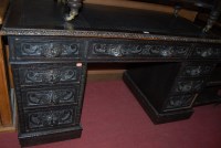 Lot 1246 - A late 19th century heavily carved oak twin...