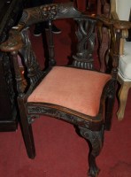 Lot 1381 - A 19th century carved oak corner chair, having...