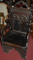 Lot 1386 - A Victorian Gothic Revival oak armchair, the...