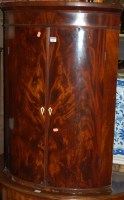Lot 1417 - A George III flame mahogany two door hanging...