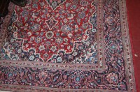 Lot 1473 - A Persian woollen Kashan rug, the red ground...