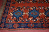 Lot 1474 - An Afghan woollen rug, the rust coloured field...