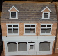 Lot 1611 - A modern wooden kit-built three-storey dolls...