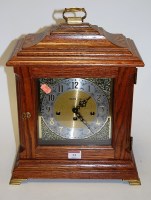 Lot 13 - A modern oak cased bracket clock, the silvered...