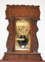 Lot 24 - A late 19th century oak cased mantel clock by...