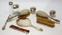 Lot 201 - A George V silver backed 9 piece dressing...