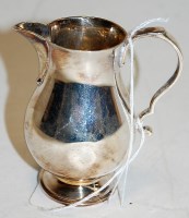 Lot 211 - A small silver bell shaped cream jug in the...