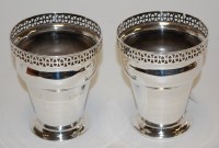 Lot 216 - A pair of Edwardian silver vases each of...