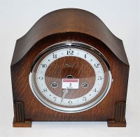 Lot 2 - A 1930s oak cased mantel clock, having...