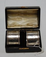 Lot 223 - A cased pair of Victorian silver napkin rings...