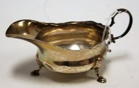 Lot 227 - An Edwardian silver cream boat having flying S...