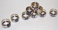 Lot 238 - A set of eight George V silver napkin rings...