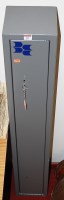 Lot 262 - A steel floor standing gun cabinet with keys