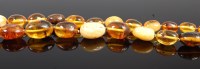 Lot 301 - A beaded amber necklace, comprising clear...