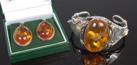 Lot 305 - A sterling silver and clear orange amber set...