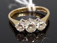 Lot 312 - An 18ct gold diamond three stone ring,...