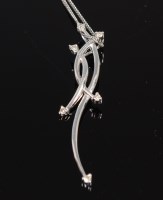Lot 313 - A 9ct gold and diamond point set pendant on...