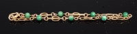 Lot 320 - A childs 9ct gold and green hardstone set...