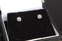 Lot 324 - A pair of modern white metal diamond ear studs,...