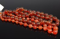 Lot 335 - A beaded and knotted agate single string...