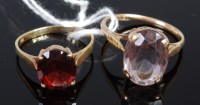 Lot 338 - A 14ct gold and garnet set dress ring;...
