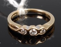 Lot 365 - A 9ct gold diamond three stone ring, the...