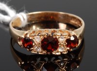 Lot 373 - An Edwardian style three garnet dress ring,...
