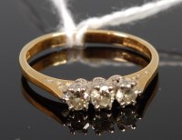 Lot 374 - An 18ct gold diamond three stone ring, the...