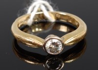Lot 381 - An 18ct gold diamond solitaire ring, the...