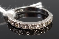 Lot 383 - An 18ct white gold diamond half eternity ring,...