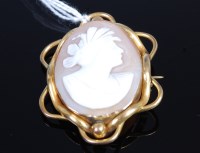 Lot 390 - A carved shell cameo brooch depicting profile...