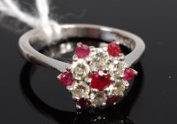 Lot 403 - An 18ct white gold ruby and diamond set flower...