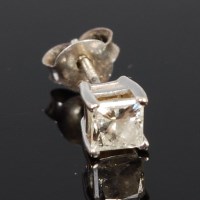 Lot 409 - A white metal single diamond ear stud, the...