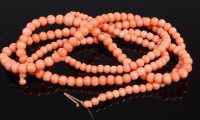 Lot 421 - A beaded and graduated coral single string...