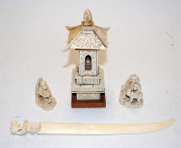 Lot 446 - A Japanese Meiji period ivory okimono carved...